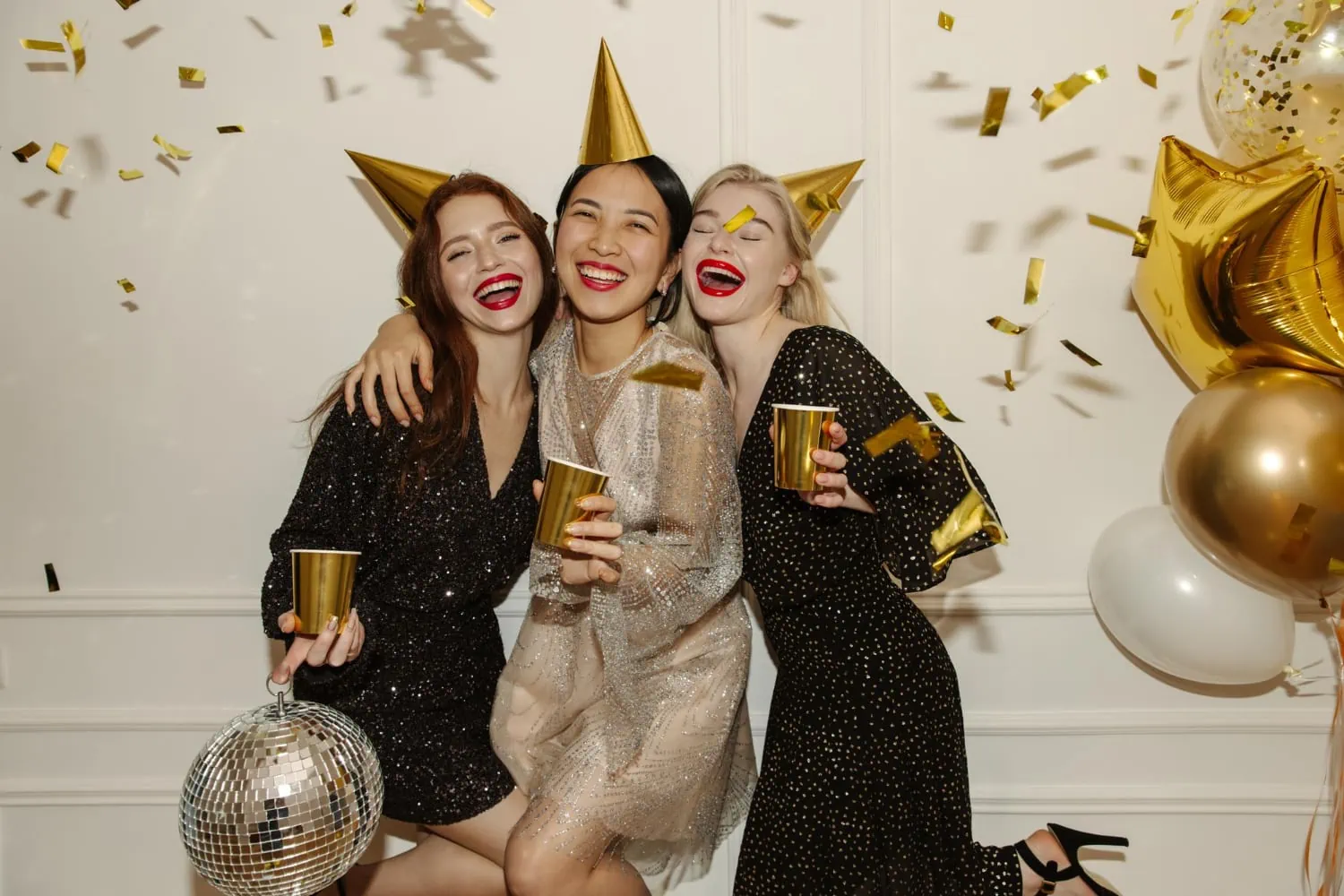 happy-young-interracial-ladies-dresses-are-walking-party-with-booze-balloons-confetti-white-background-happy-weekend-concept