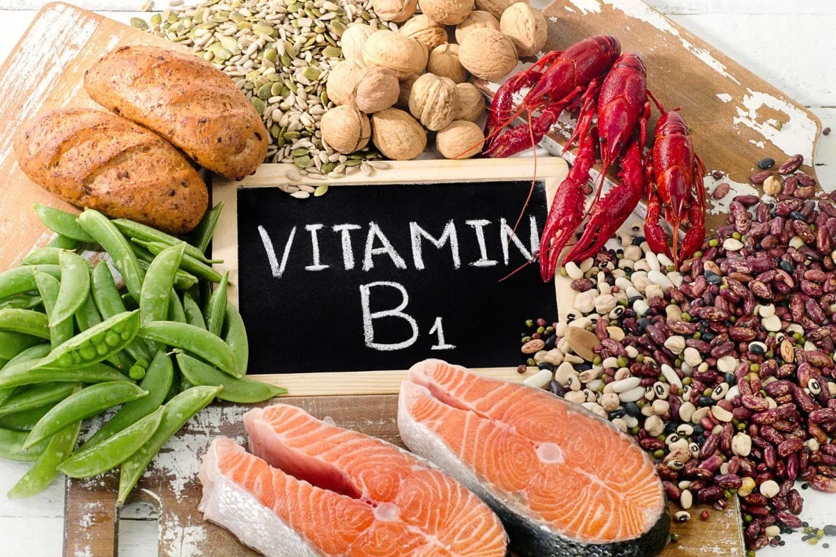Vitamin B1 foods including salmon, peas, walnuts, beans, bread, and crayfish.